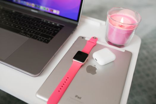 Witte AirPods in oplaadcase naast iPhone en MacBook op tafel in Oudgouda